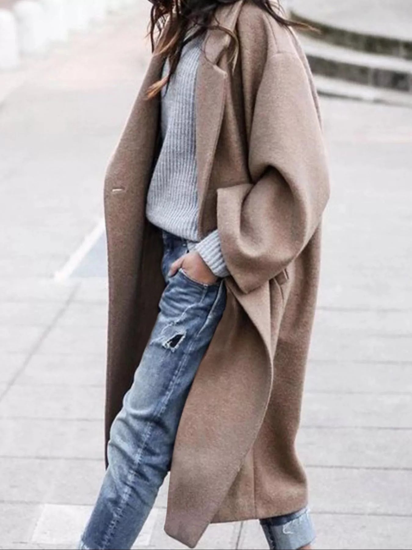 Women's oversized long coat in taupe with wide sleeves and single-breasted closure styled with ribbed jumper