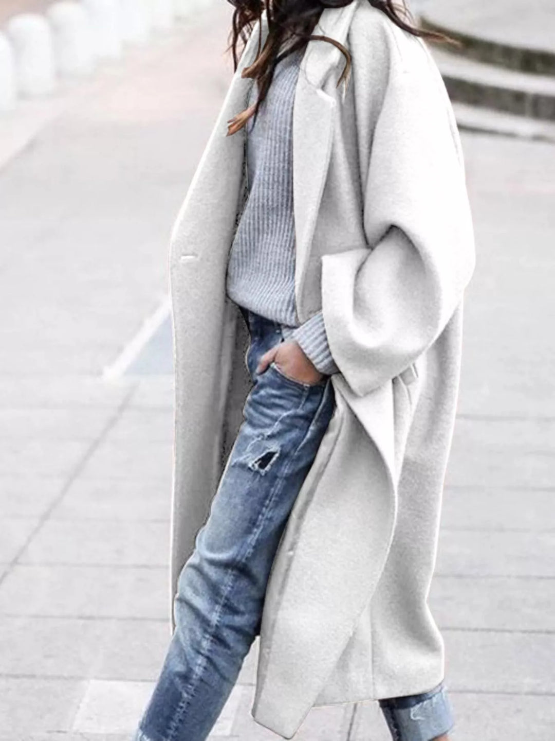 Women's oversized long coat showing structured fabric drape and knee-length cut for versatile everyday wear