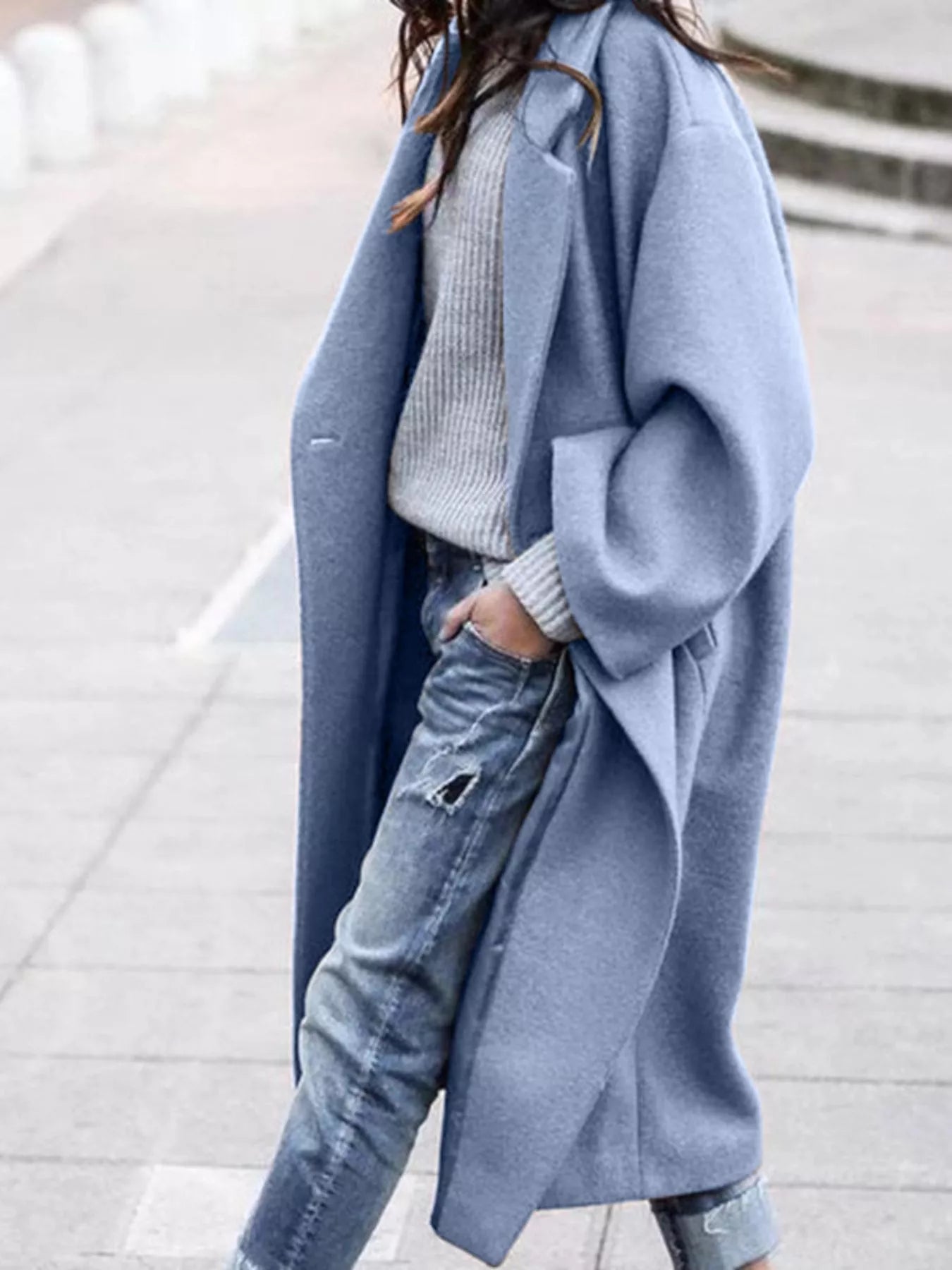 Full-length view of women's oversized long coat in taupe featuring dropped shoulders and relaxed silhouette