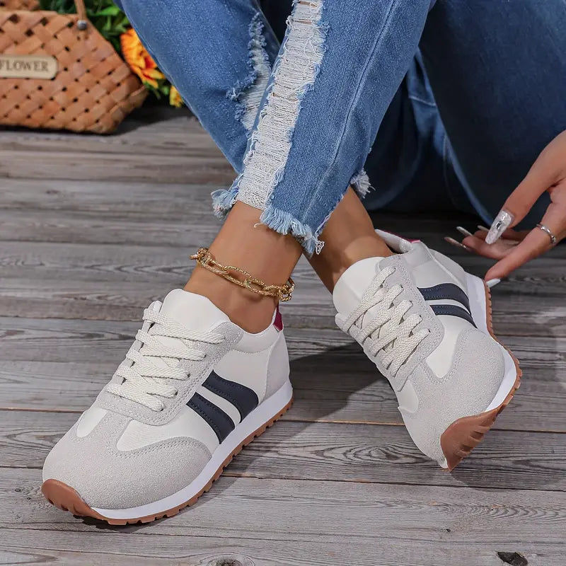 Side view of women's casual trainers featuring suede panelling and classic running silhouette