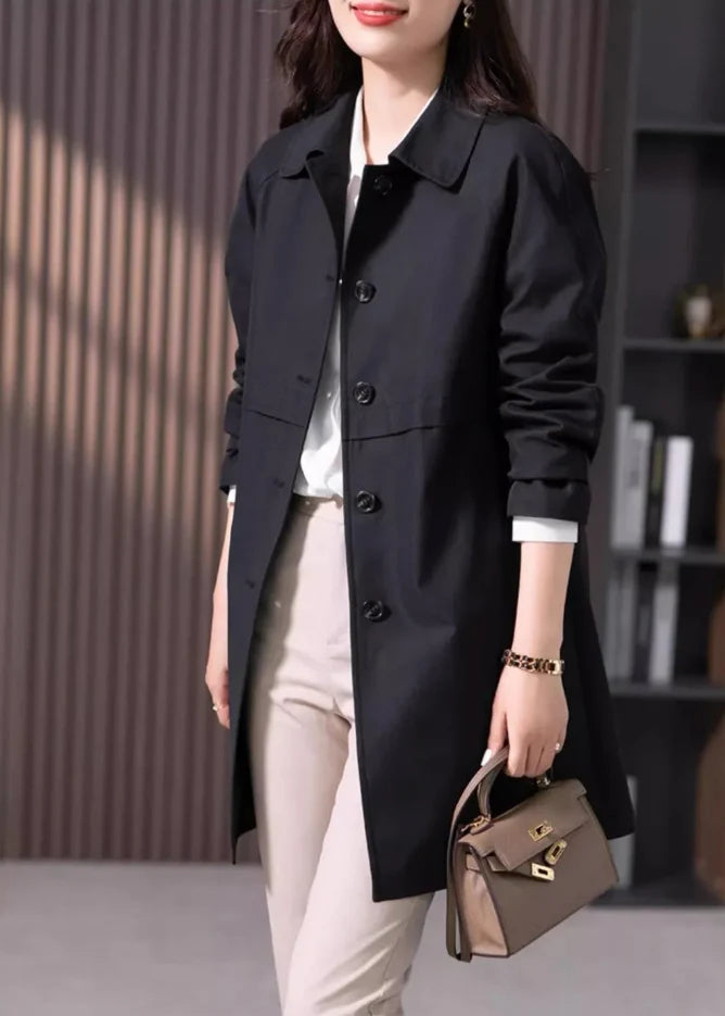 Short trench coat in black featuring smooth fabric finish and relaxed fit for layering