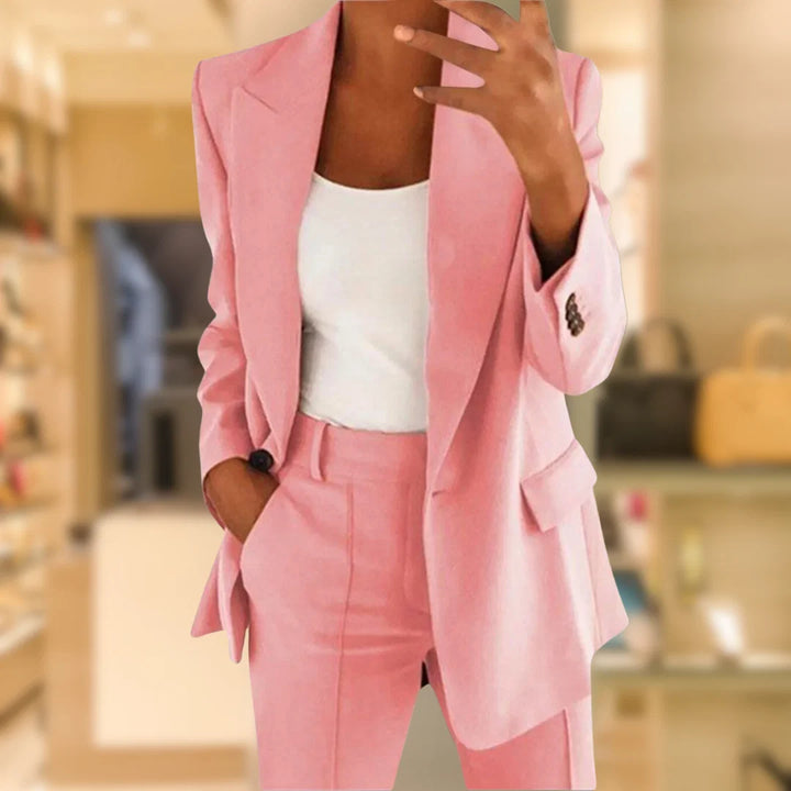 Women's two-piece suit set styled with white top showing relaxed fit blazer and mid-rise trousers