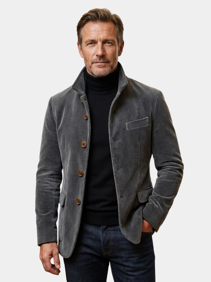Men's grey corduroy blazer jacket with button-front closure and tailored fit worn over black turtleneck