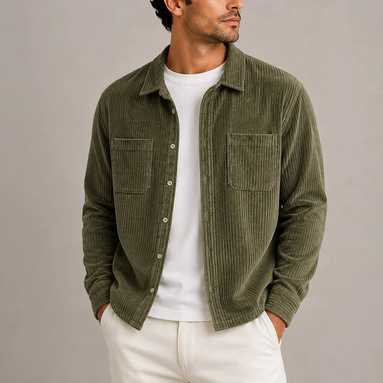 Men's corduroy overshirt in olive green with button-up front and chest pockets worn over white tee