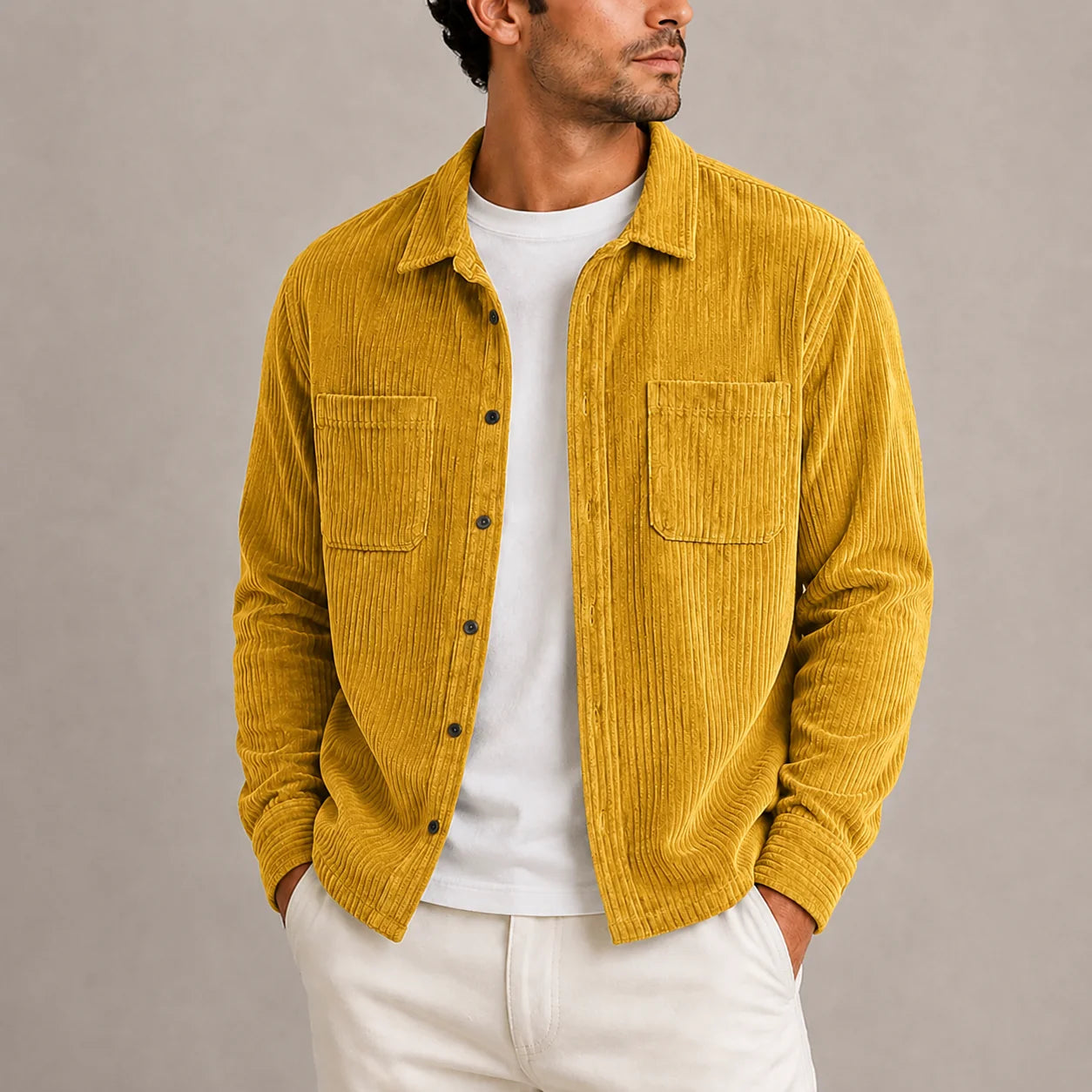 Detail shot of men's corduroy overshirt chest pocket and button-through front closure