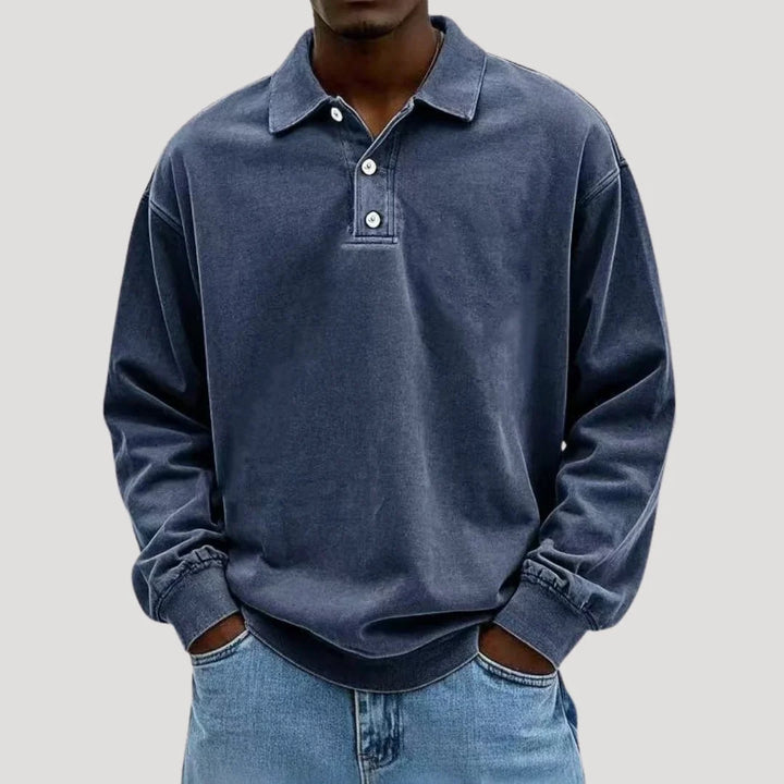 Close-up of button placket detail on men's long sleeve polo with brushed fabric finish