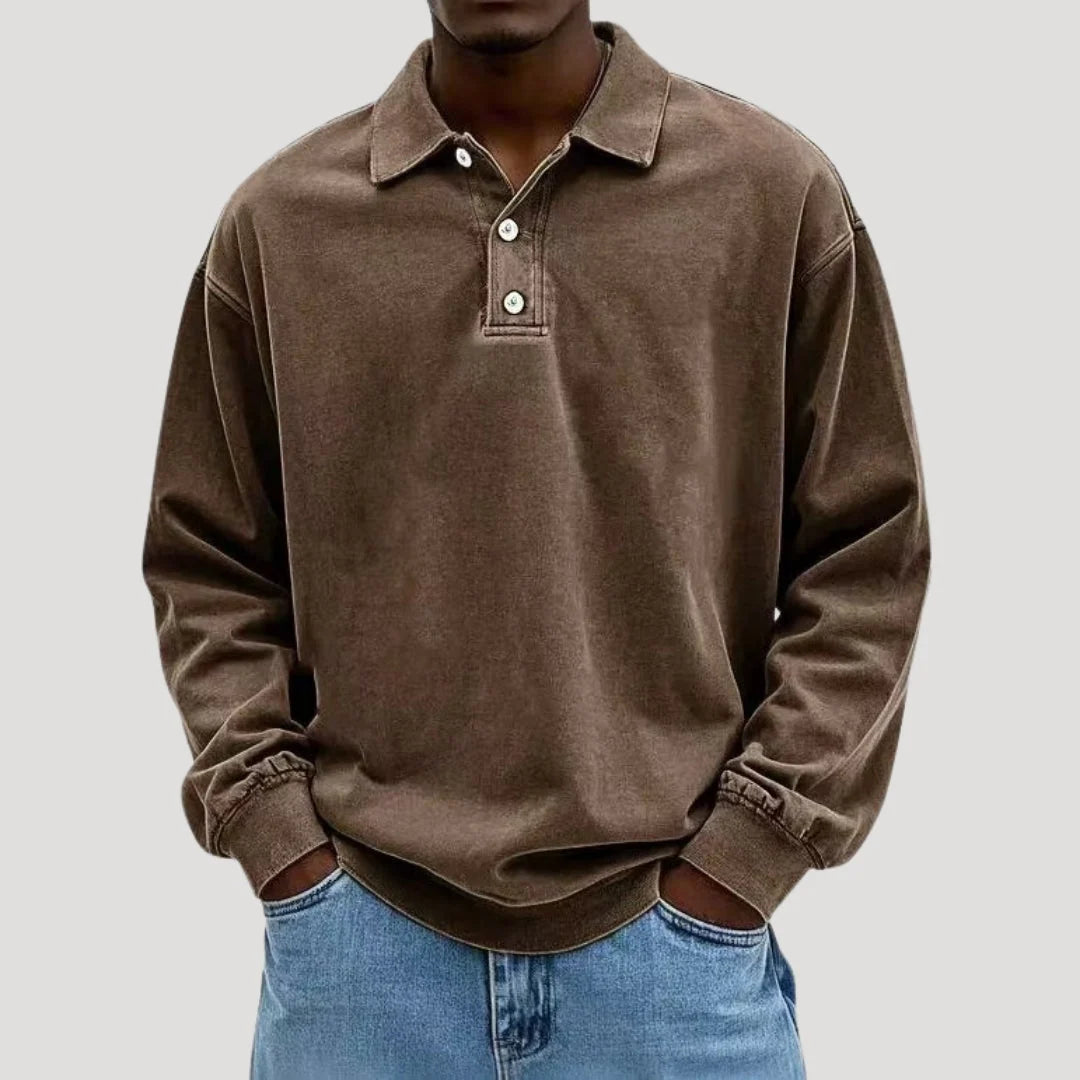 Side angle of relaxed fit long sleeve polo shirt with ribbed cuffs and dropped shoulder