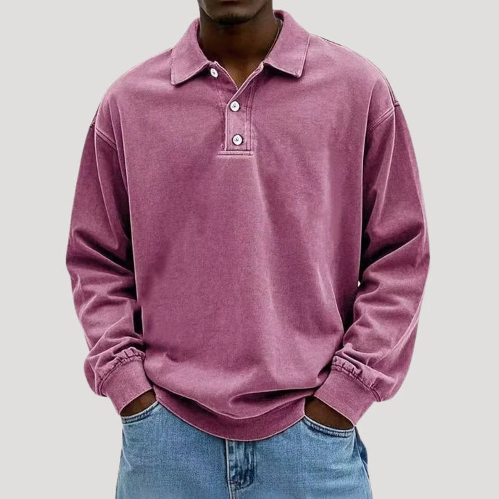 Men's charcoal polo shirt styled with light wash denim jeans for casual layering