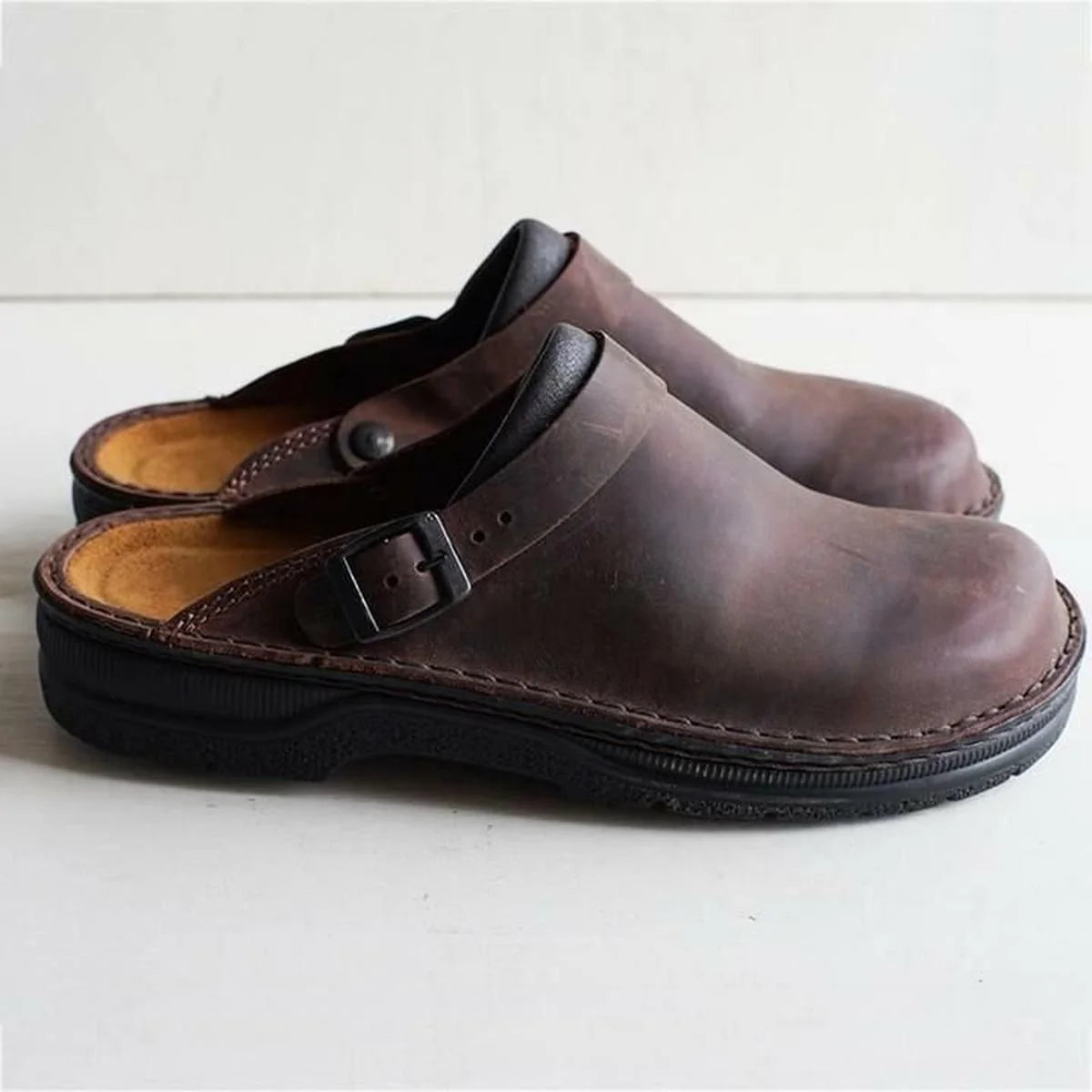 Close-up of contoured footbed in men's arch support mules with visible cushioning and anatomical shape