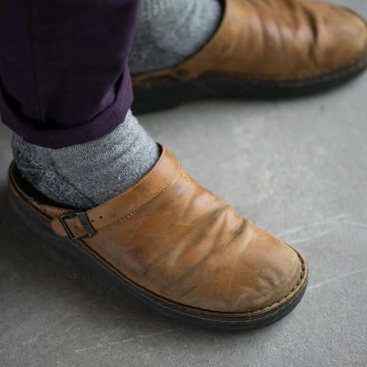 Men's black mules with smooth upper and grippy outsole suitable for indoor and outdoor wear