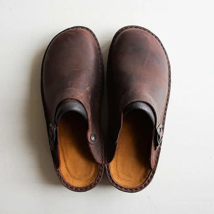 Pair of men's arch support mules showing adjustable side buckle and contoured insole design
