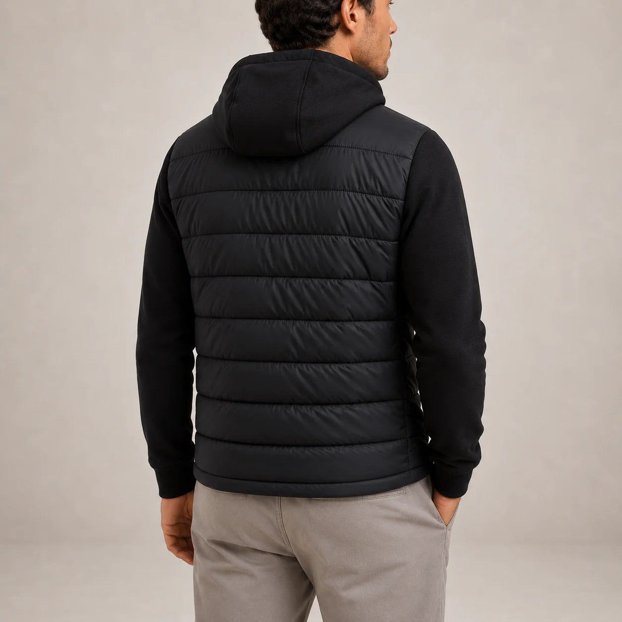 Close-up of men's hybrid puffer jacket showing quilted insulated body and ribbed knit sleeves