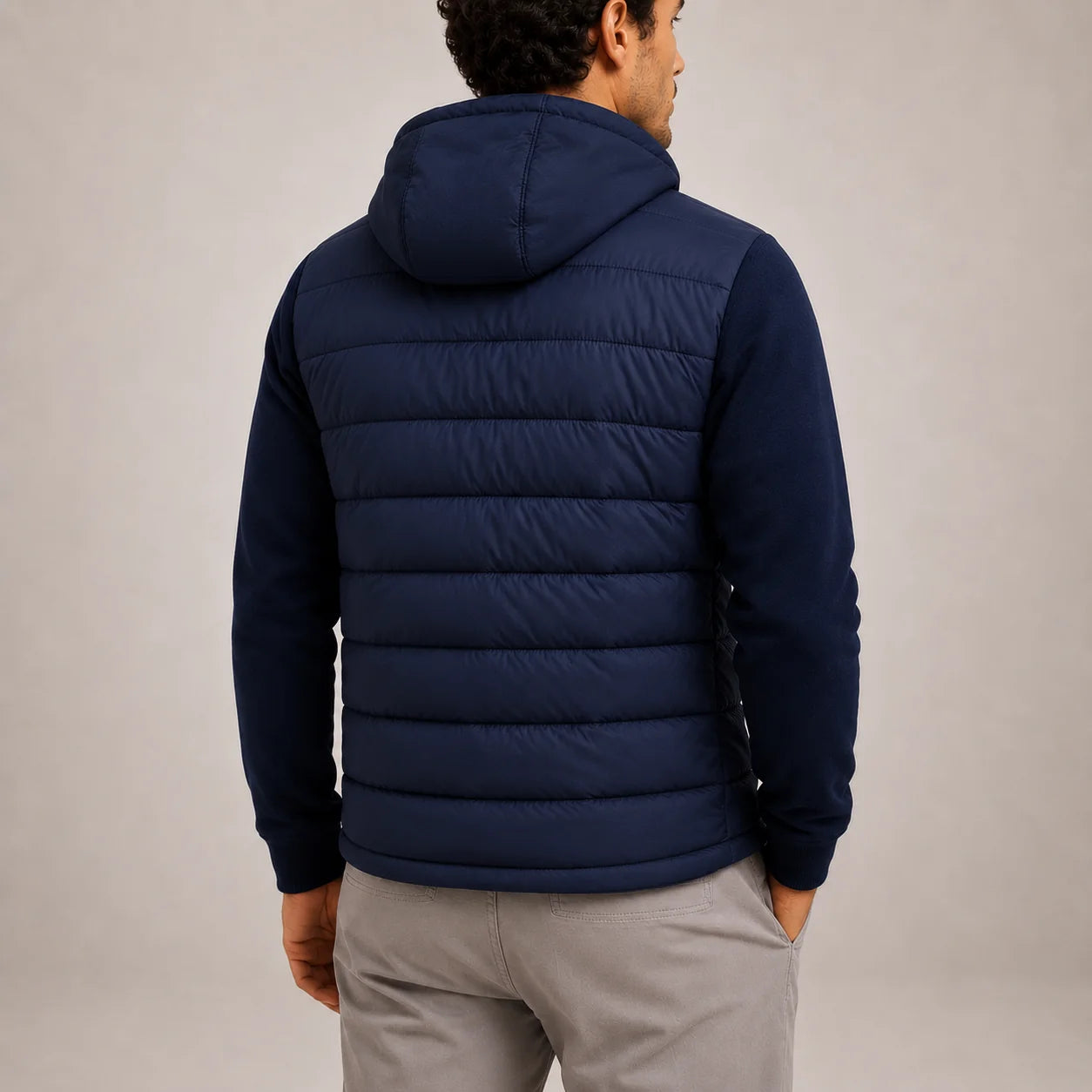 Men's hooded hybrid jacket in black with knit sleeves and quilted torso panel