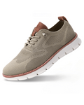 Men's knit trainers in beige with textured mesh upper, lace-up front, contrast heel tab, and cushioned sole.