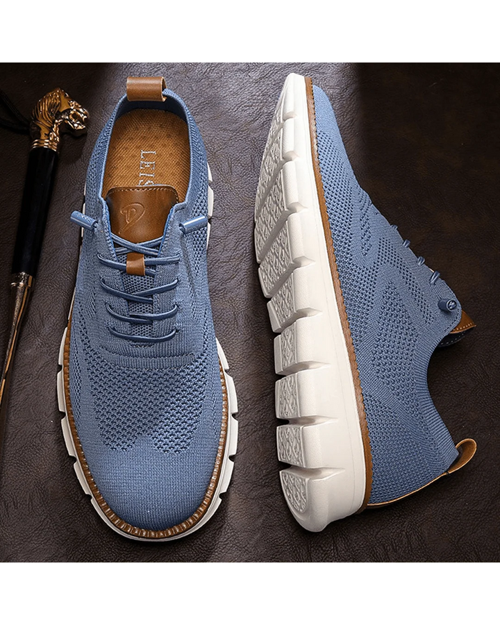 Men's knit trainers in white showing clean mesh upper and flexible outsole construction.