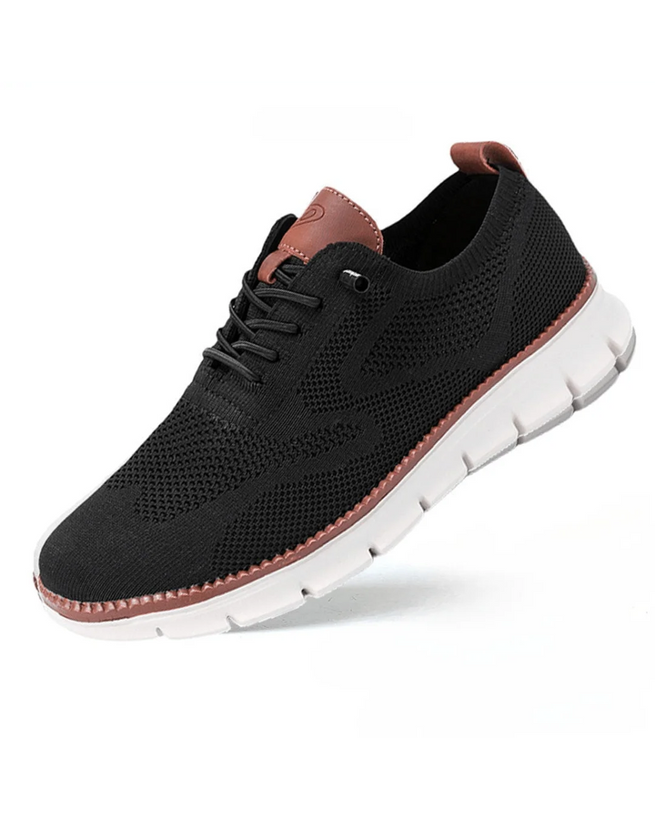 Side view of men's knit trainers showing textured mesh construction and flexible ridged outsole.