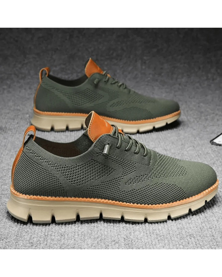 Men's knit trainers in blue colourway from side view with cushioned sole visible.