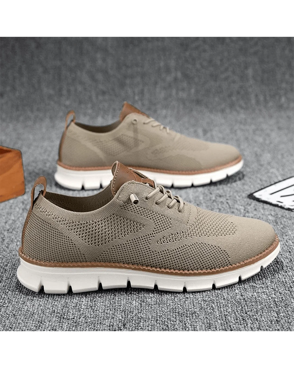 Men's knit trainers in beige showing lace-up closure and breathable mesh construction.