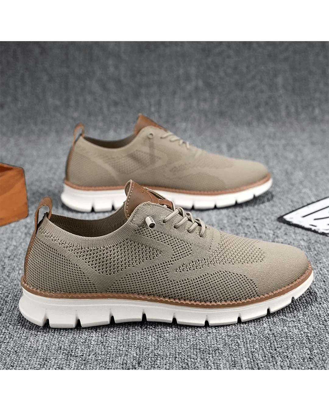 Men's knit trainers in beige showing lace-up closure and breathable mesh construction.