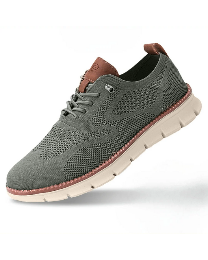 Front angle of men's knit trainers displaying rounded toe and breathable mesh upper.