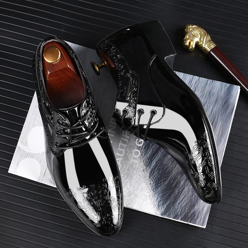 Detail of tonal embossed pattern across toe cap of black patent formal shoes