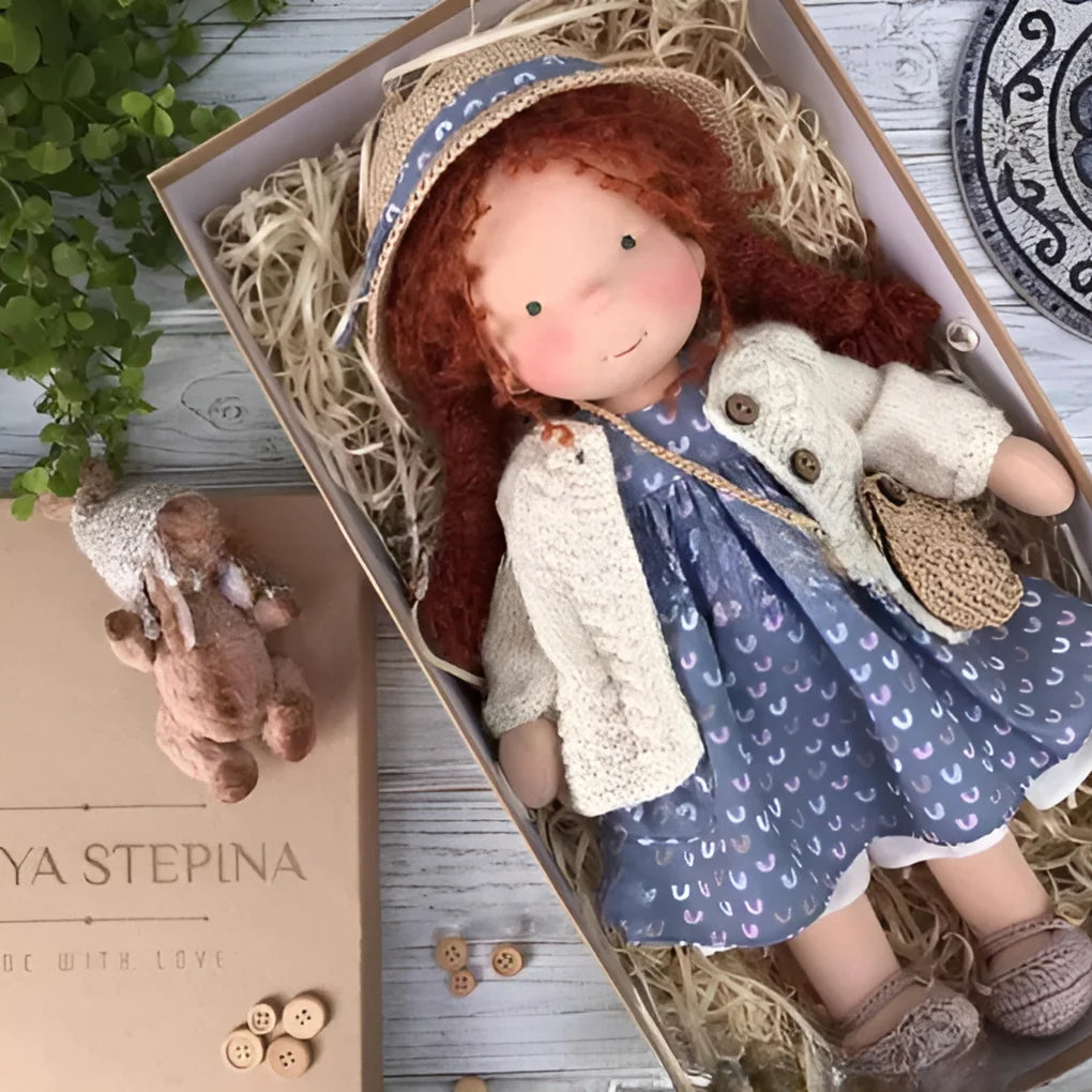 Handmade Waldorf doll lying in gift box with natural cotton and wool construction