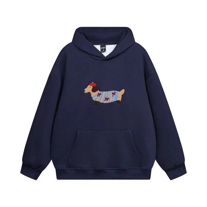 Close-up of embroidered dachshund detail on grey hoodie chest with adjustable drawstring hood