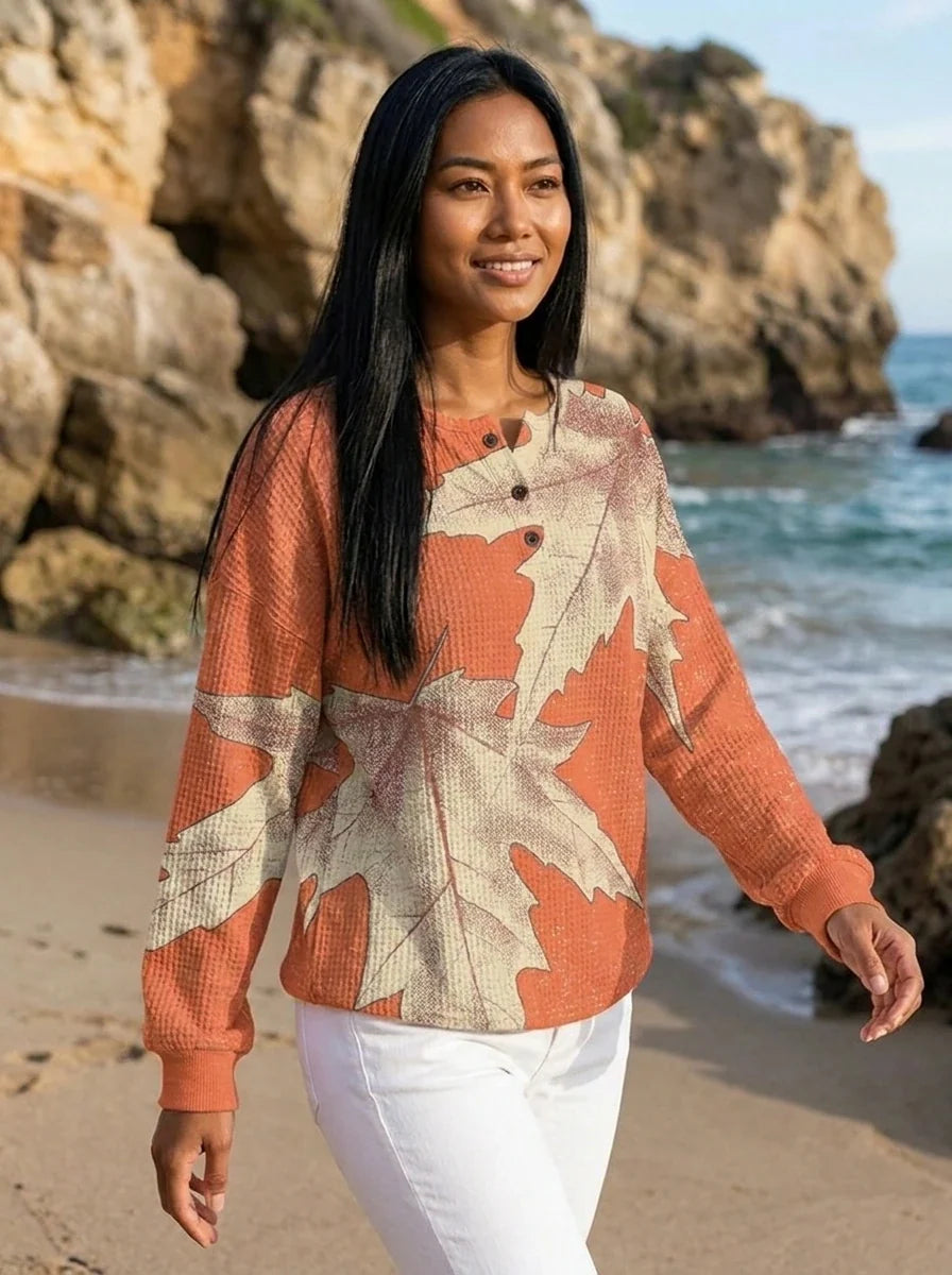 Side view of relaxed fit leaf print blouse showing hip-length hem and long sleeves