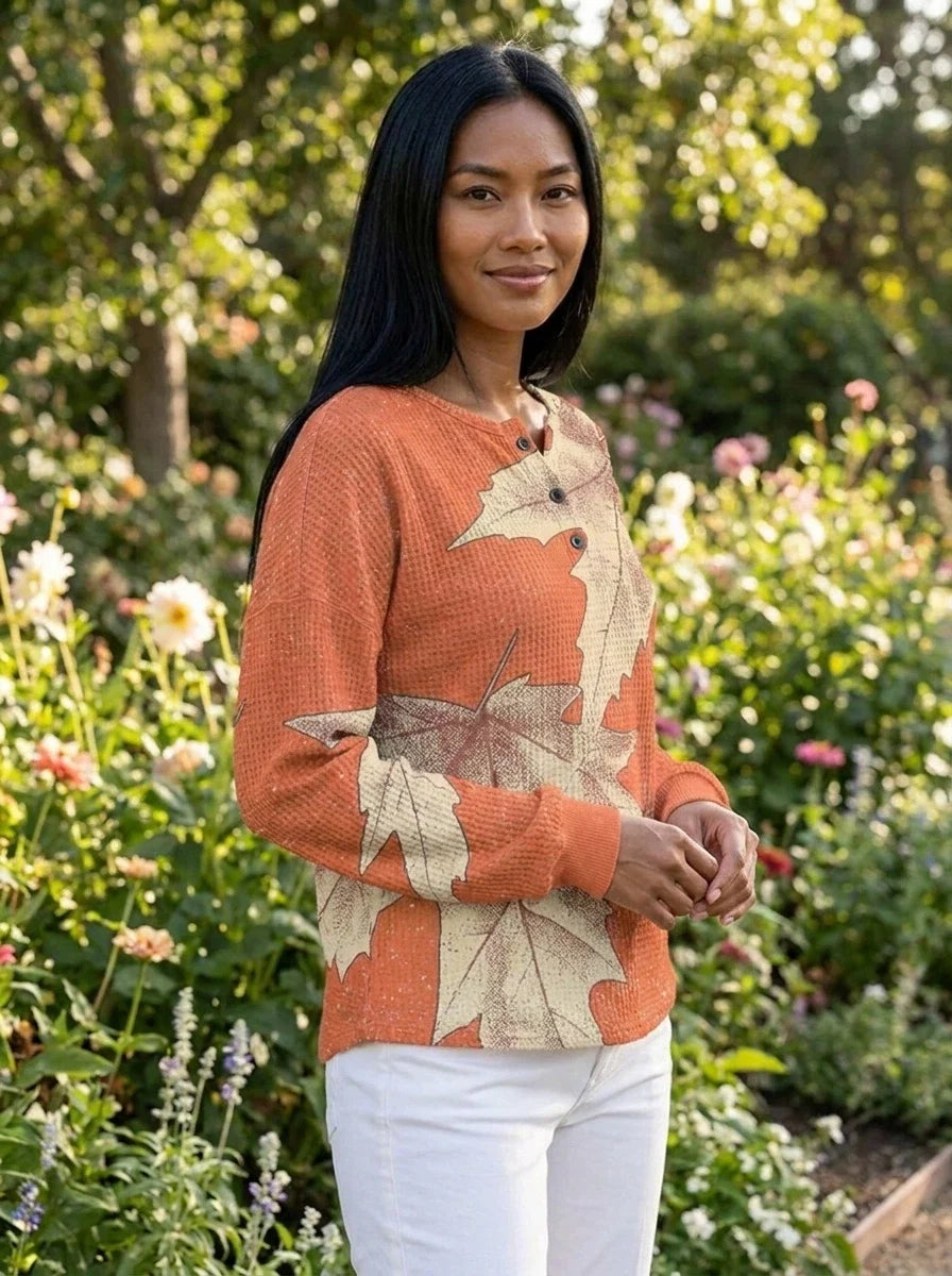 Back view of women's peach leaf print blouse with V-neckline and fluid drape