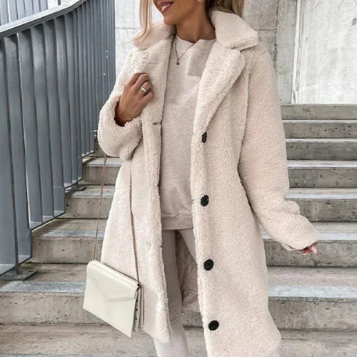 Women's teddy coat in cream with notched collar and button front closure, styled with trousers