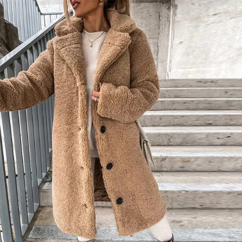 Side angle of women's teddy coat with notched collar detail and button fastening