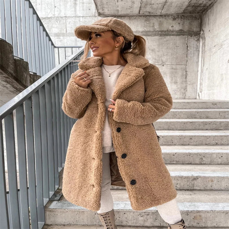 Women's teddy coat in cream layered over casual knitwear for autumn winter styling