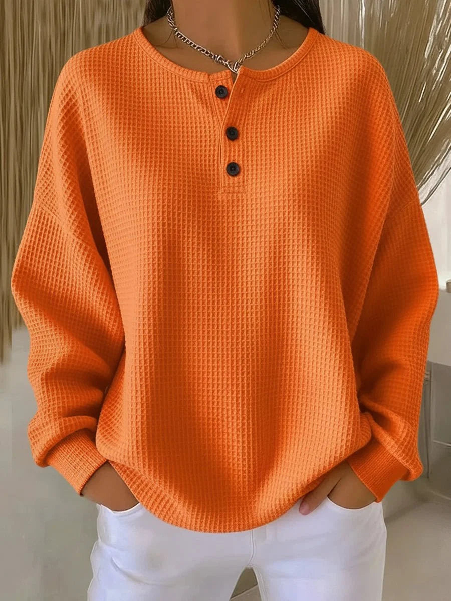 Women's waffle knit henley jumper in orange with three-button placket and drop shoulders