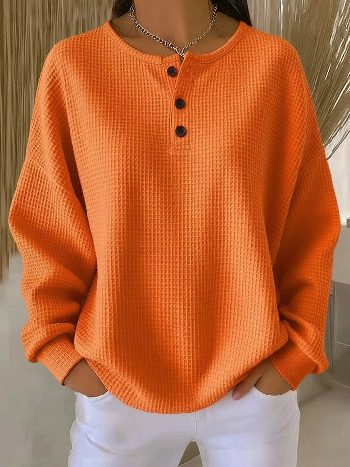 Women's waffle knit henley jumper in orange with three-button placket and drop shoulders