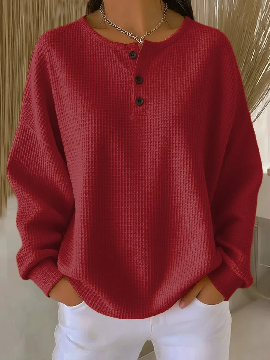 Side view of oversized waffle knit jumper with relaxed fit and long sleeves