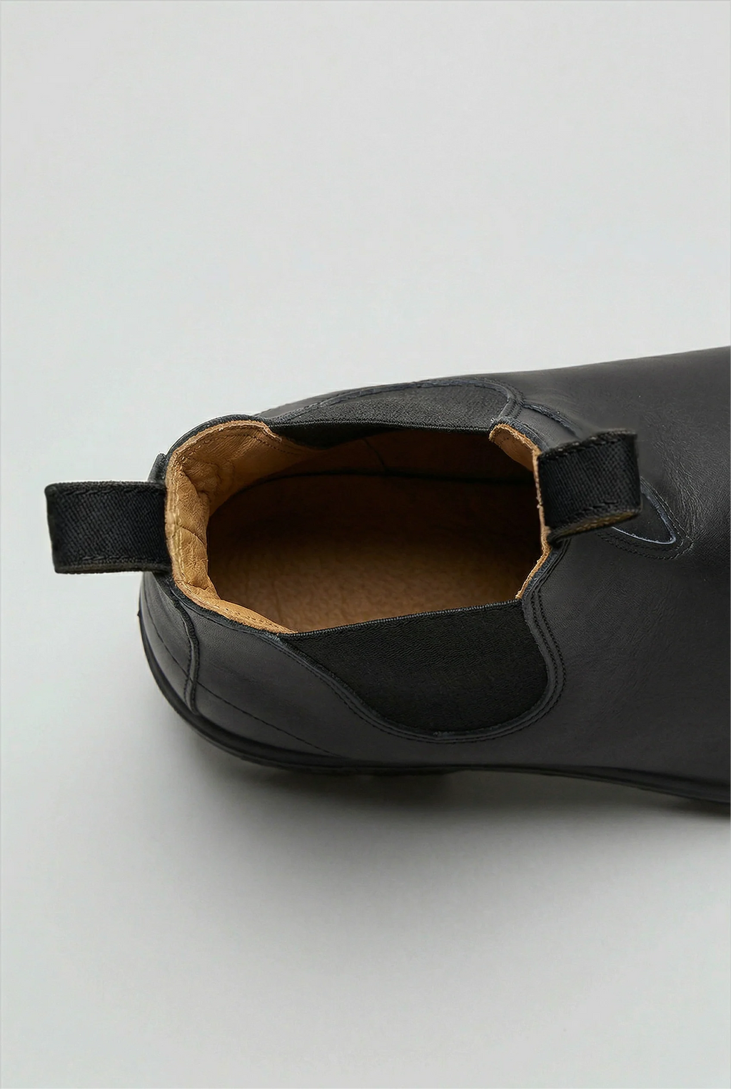 Rear view of Chelsea boots featuring pull loop and structured heel counter