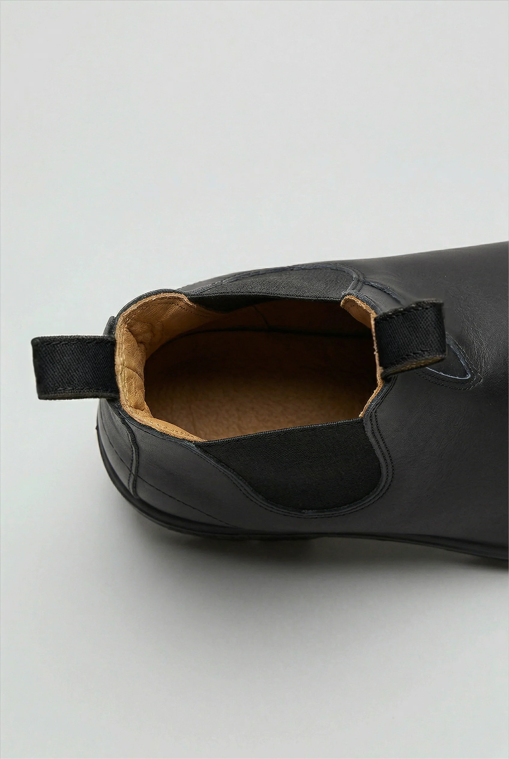 Rear view of Chelsea boots featuring pull loop and structured heel counter