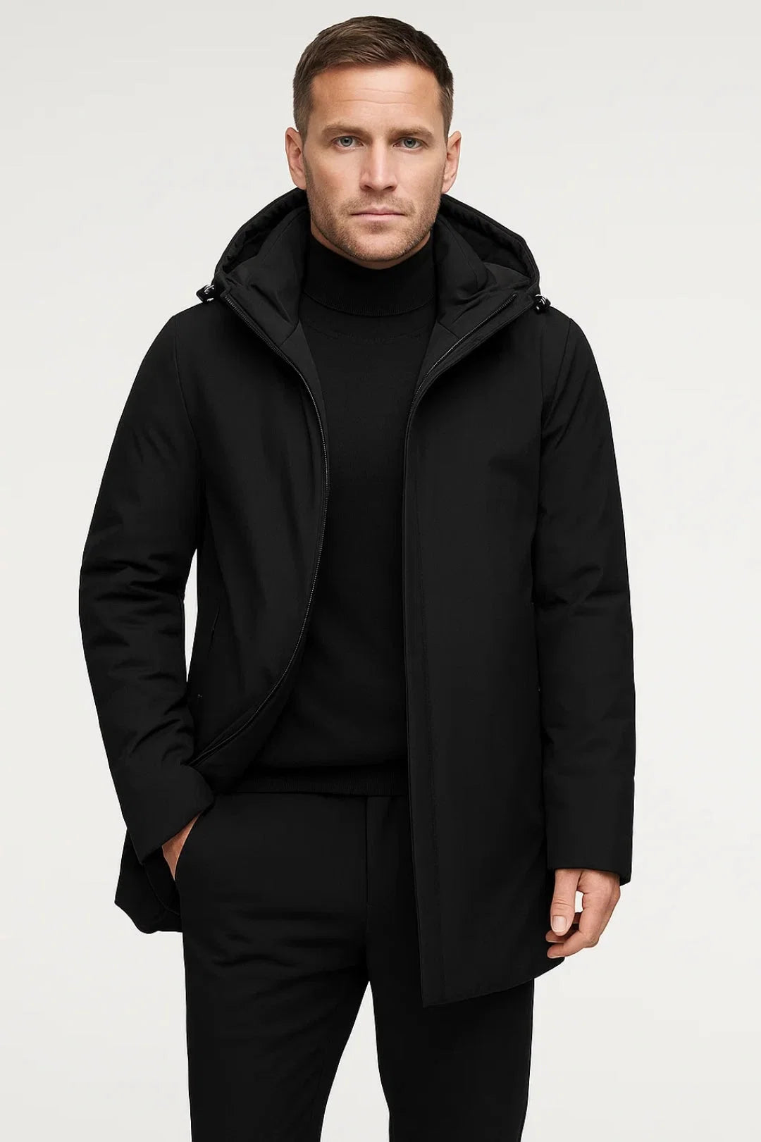 Men's hooded parka coat styled over black turtleneck jumper for smart-casual winter outfit