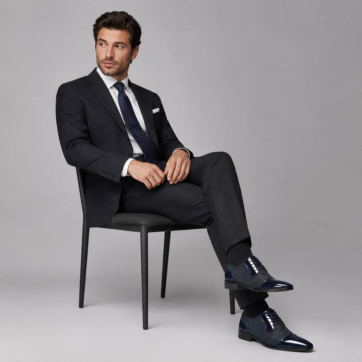 Side view of men's formal Oxford shoes showing glossy patent finish and lace-up construction