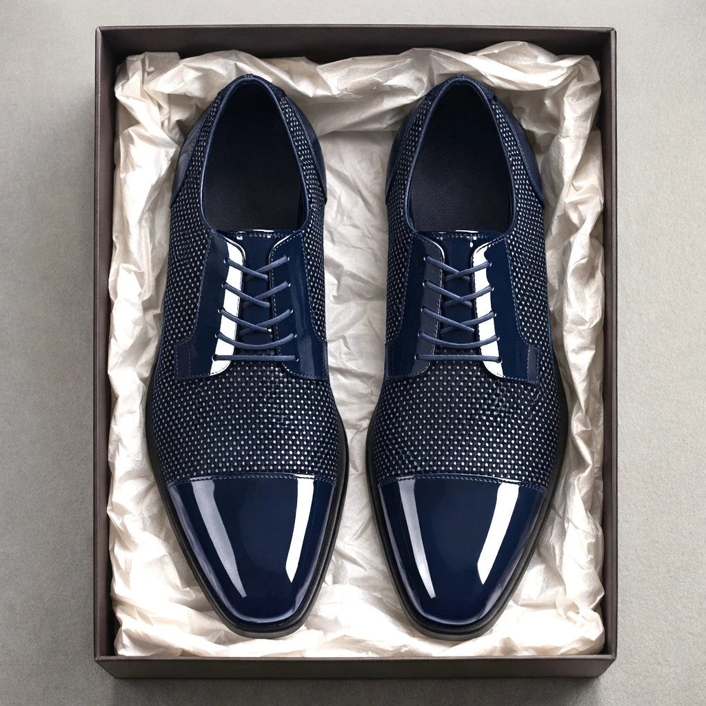 Close-up of cap toe Oxford shoes with contrast mesh panels and structured silhouette