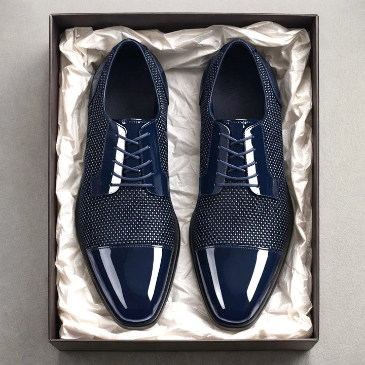 Close-up of cap toe Oxford shoes with contrast mesh panels and structured silhouette