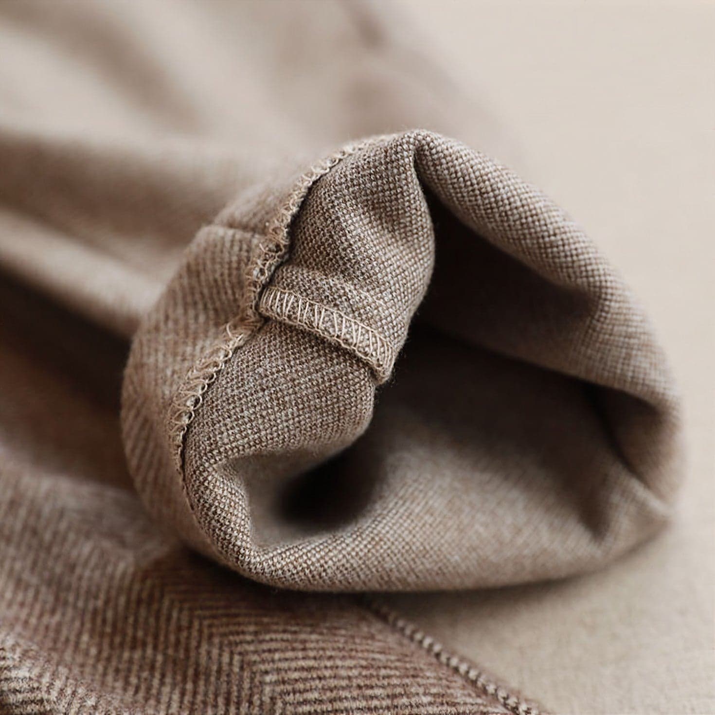 Back view of men's herringbone trousers showing clean lines and tailored fit