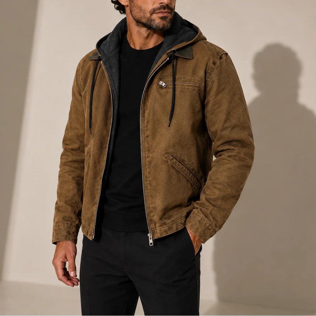 Close-up view of men's hooded jacket showing zip chest pocket and structured outer fabric detail