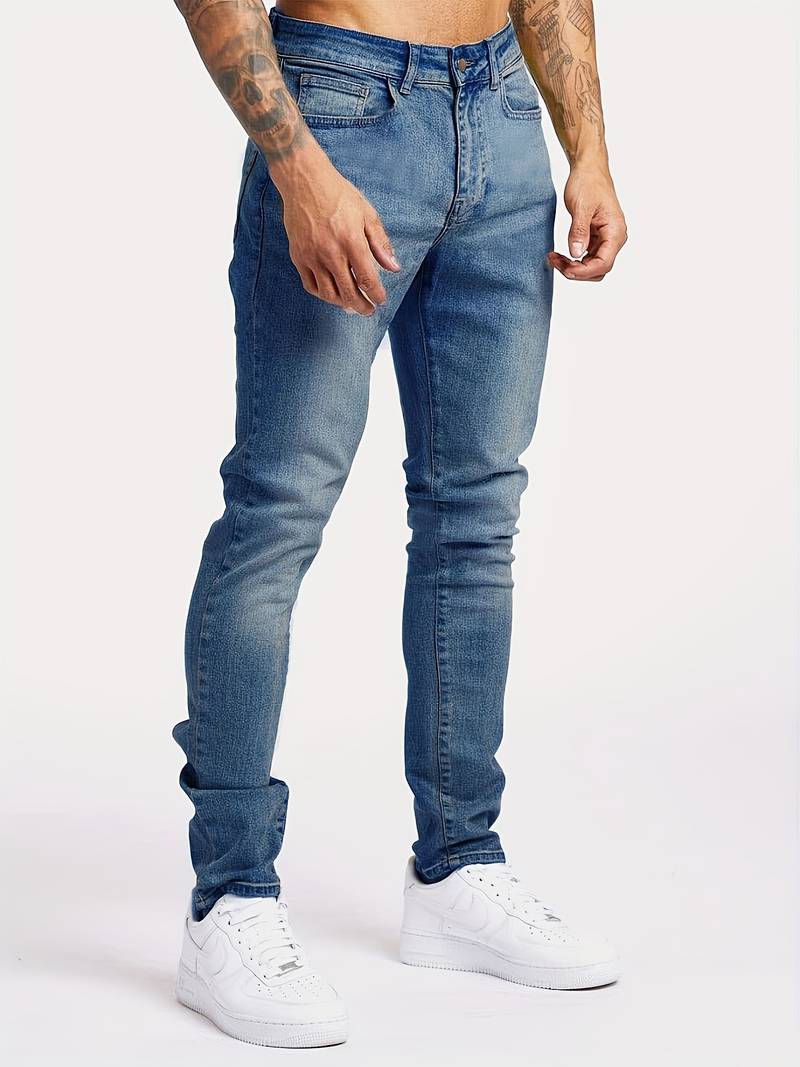Men's slim fit jeans in faded wash with tapered leg and five-pocket styling