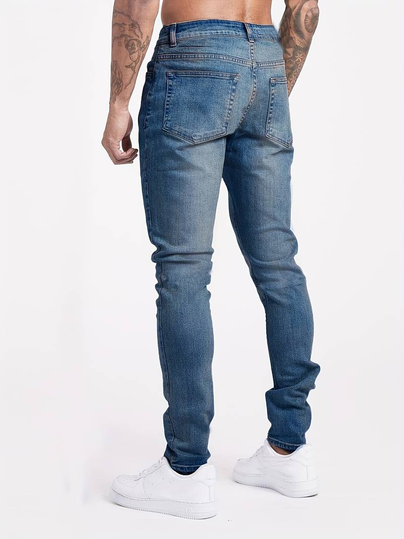 Close-up view of men's slim fit jeans showing faded wash detail and structured fabric