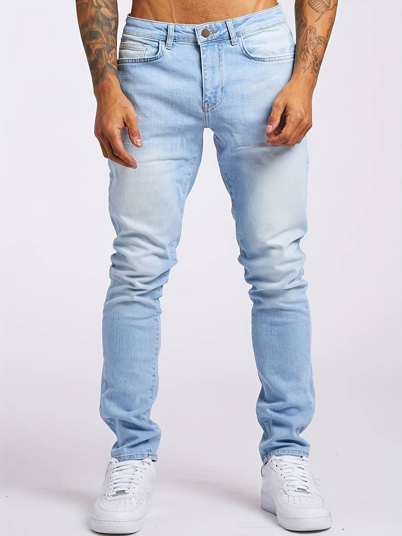 Men's faded wash jeans styled with white trainers for casual wear