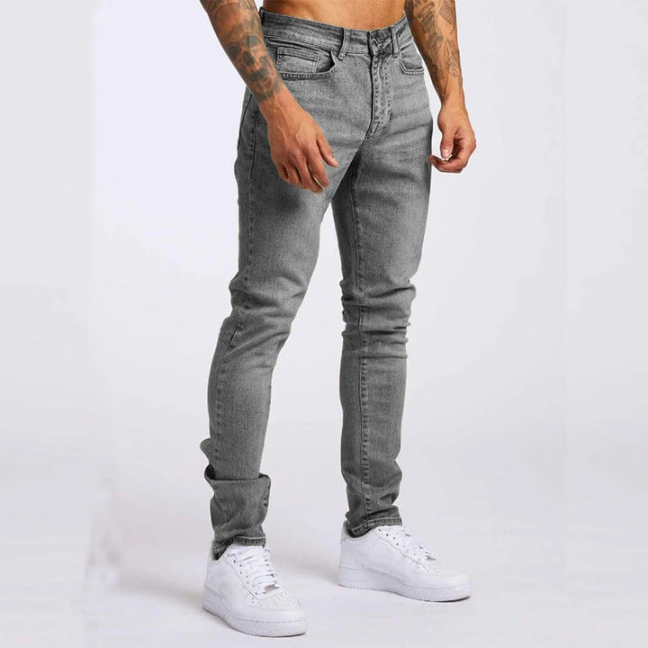 Men's casual jeans featuring five-pocket design and slim fit through leg