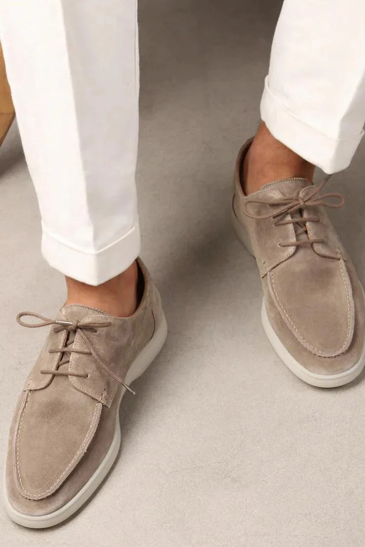 Detail of lace-up construction on men's suede loafers showing adjustable fit and polished design
