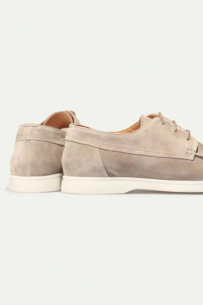 Rear view of men's suede lace-up loafers displaying structured heel and tailored silhouette