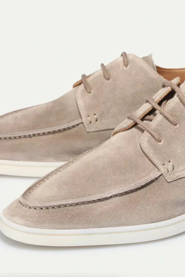 Men's navy suede loafers styled for smart casual occasions with versatile lace-up detail